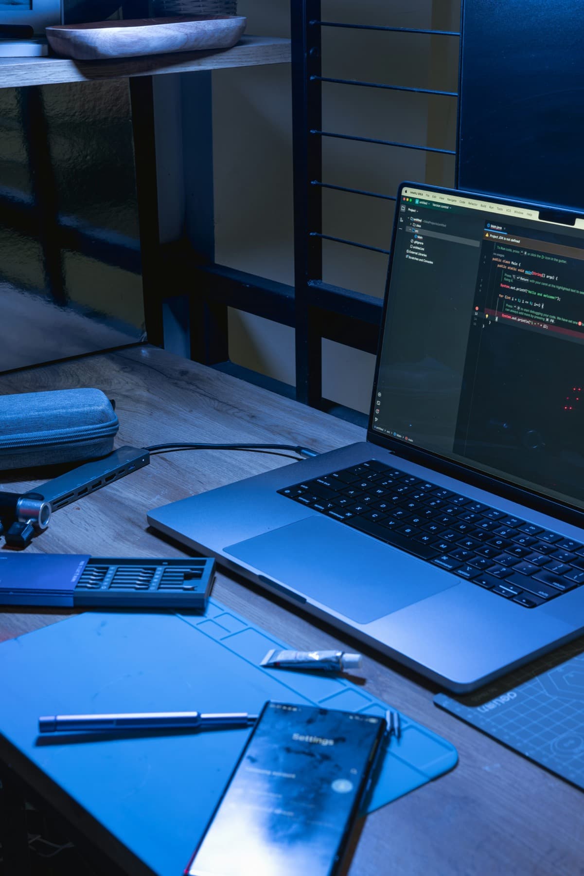 A developer's laptop showing production code in a dark editor